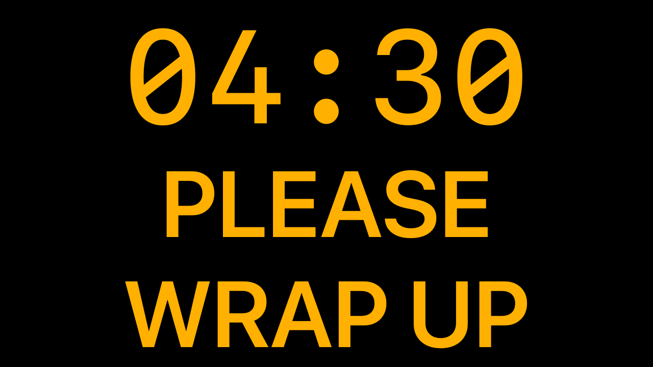 Downstage showing a full-screen message overlay reading a presenter cue over the timer.