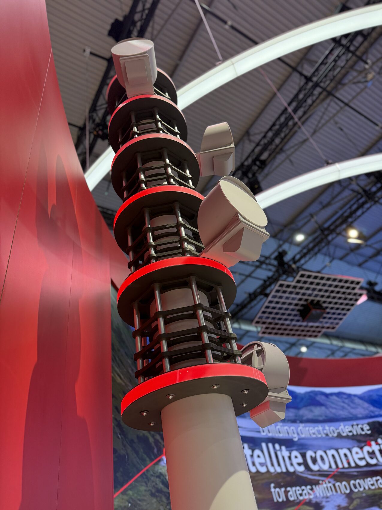 The three-metre Vodafone cell tower model — stacked antenna arrays with LED light discs between them, on the Vodafone stand.