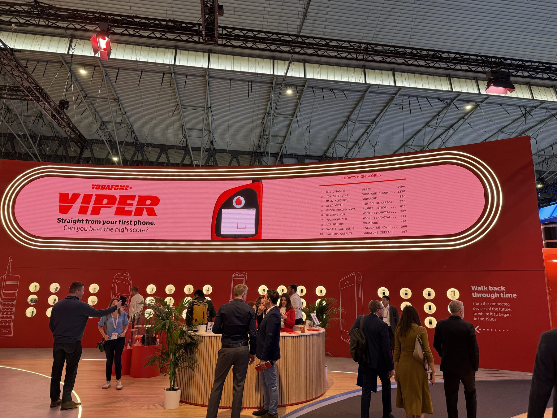 The racetrack-shaped LED wall reading 'Vodafone Viper — straight from your first phone, can you beat the high score?', with the day's high scores listed beside the game.